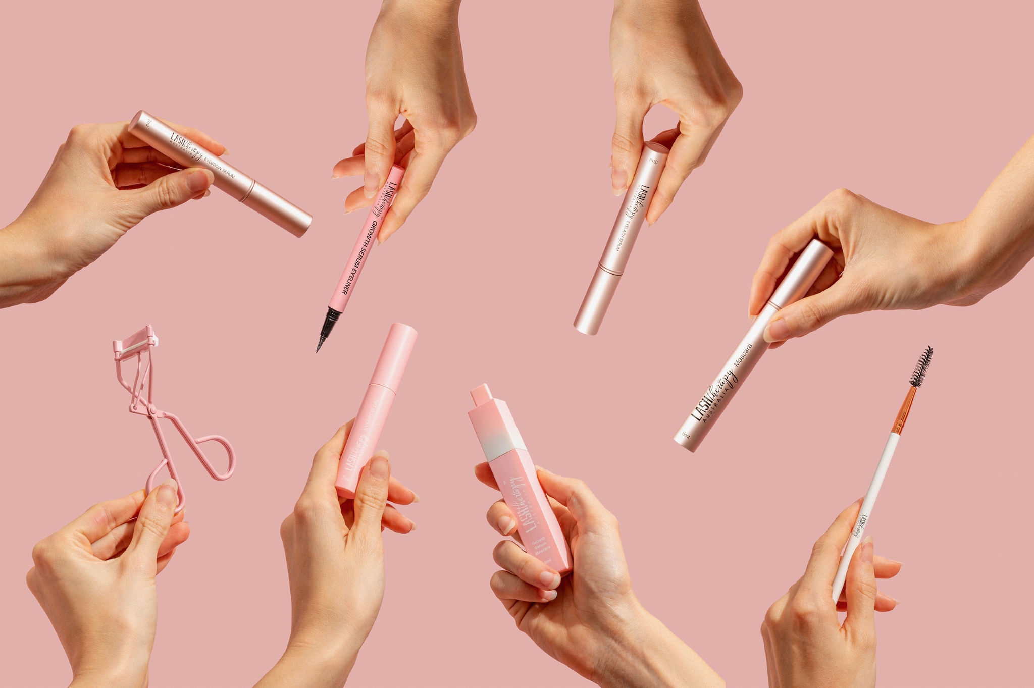 hands-showing-lash-therapy-products-over-pink-background