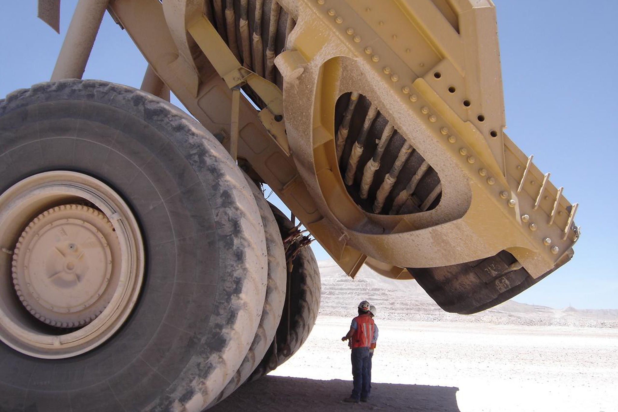 man-standing-under-earth-moving-equipment